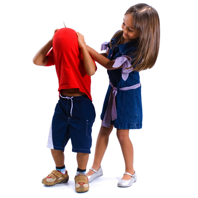 Girl helping boy put on shirt.